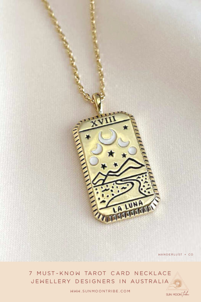 A gold The Moon tarot card pendant on a gold necklace.