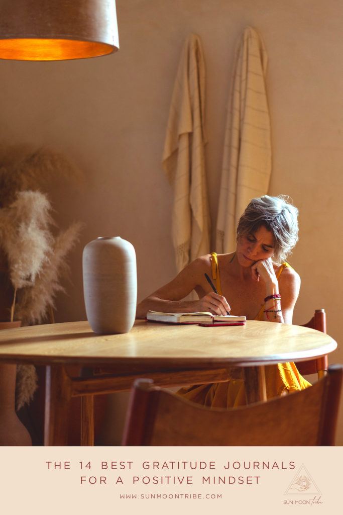 A woman sitting at a table journaling.