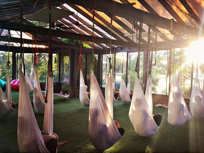 A room filled with aerial yoga silk wraps.