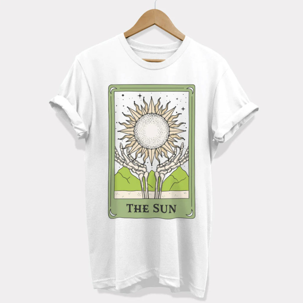A white t-shirt with The Sun Tarot Card design