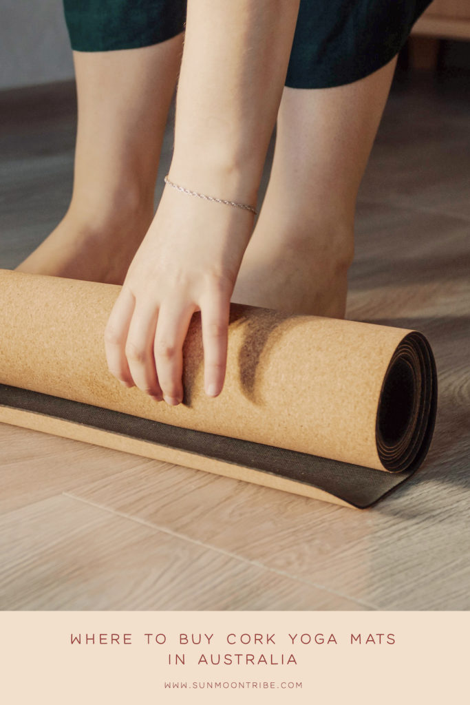 Person rolling out a cork yoga mat