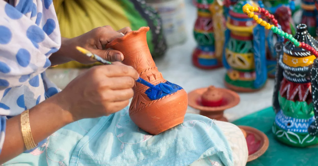Person hand-painting vase | Fair Trade gifts Australia