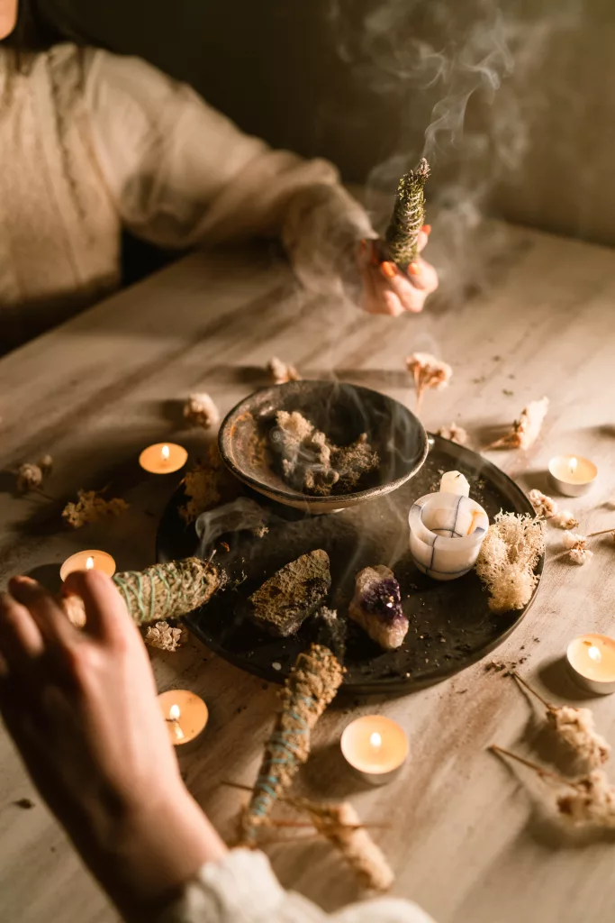 A group of people house cleansing with sage